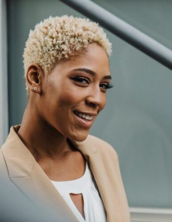 happy-confident-black-businesswoman-by-steps_53876-106352